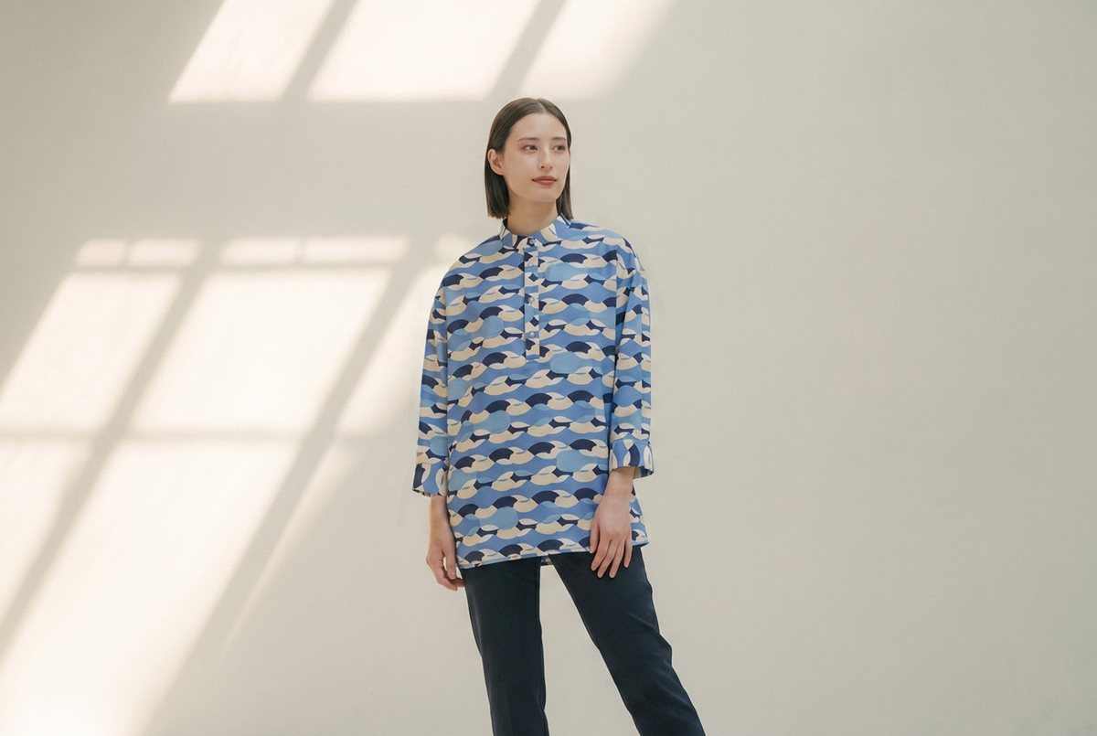 q-bicホテルのユニフォームを着用した女性スタッフ。