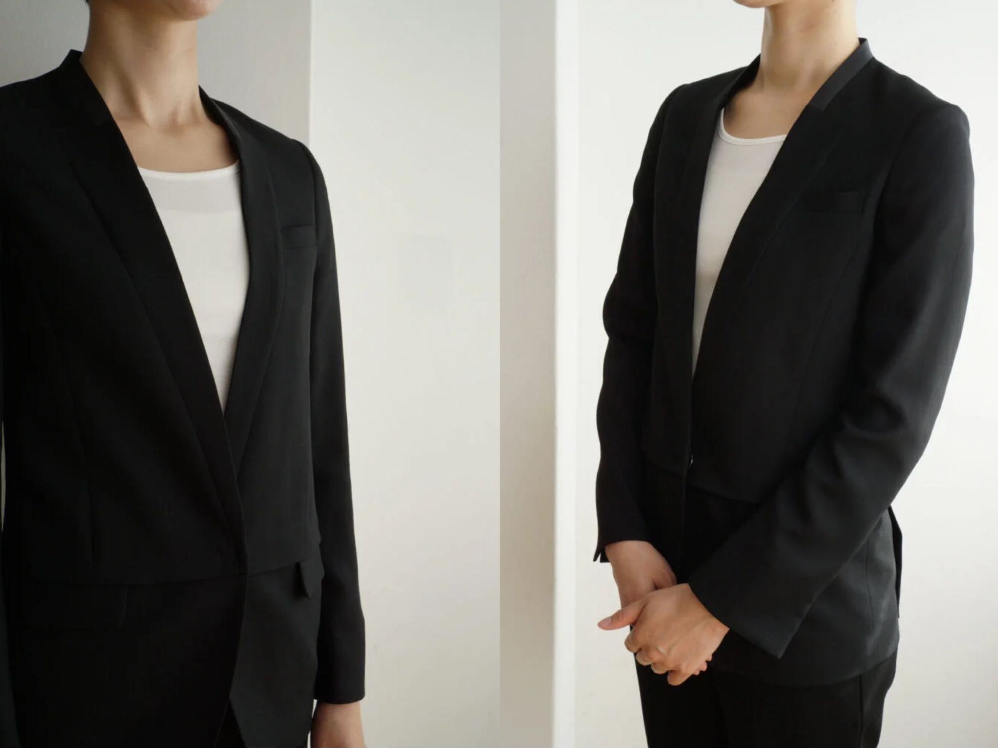 ブラックのノーカラージャケットと白いブラウスを着用したスタッフ