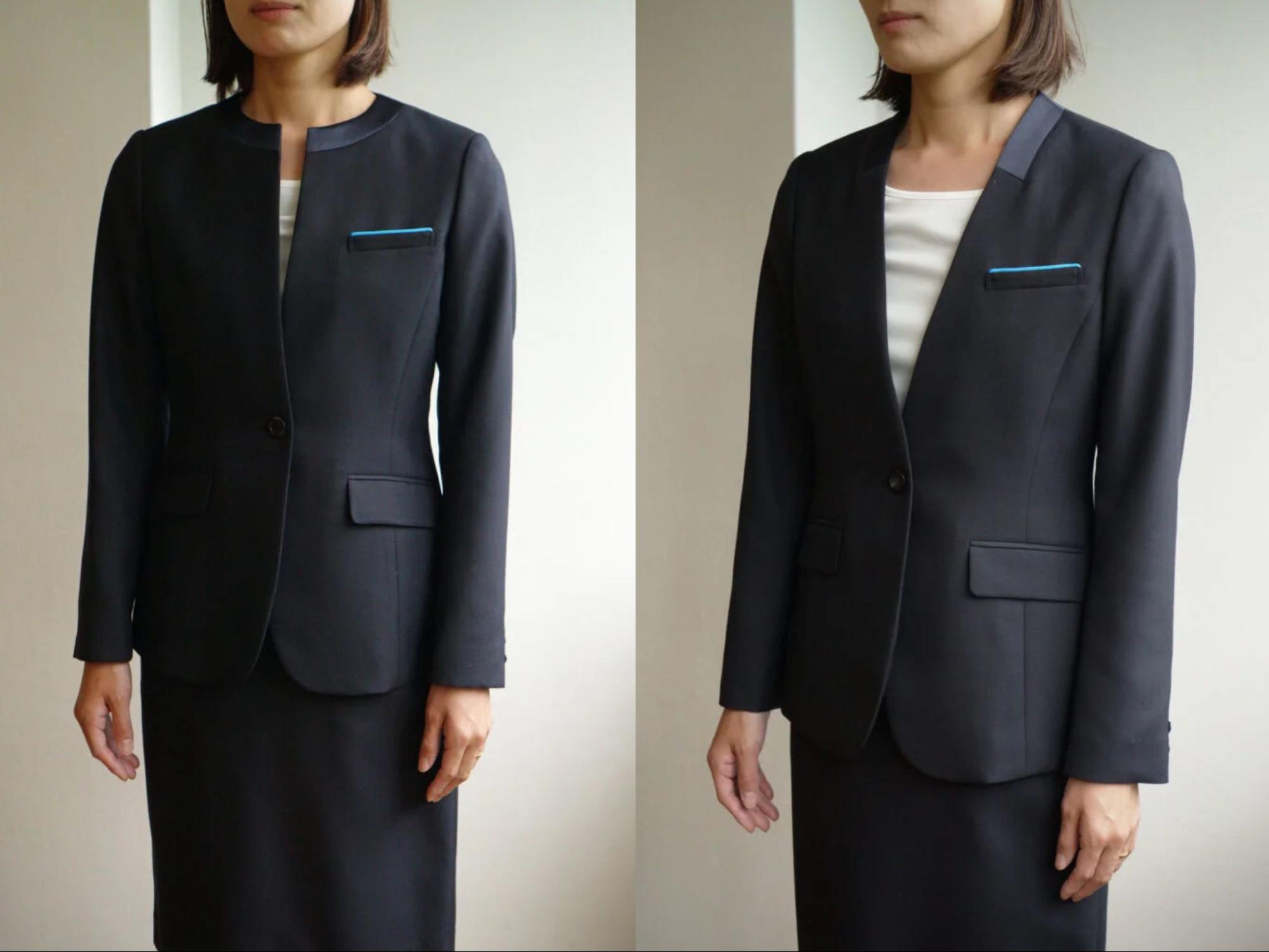 ブラックのノーカラージャケットとスカート、白いブラウスを着用した女性スタッフ