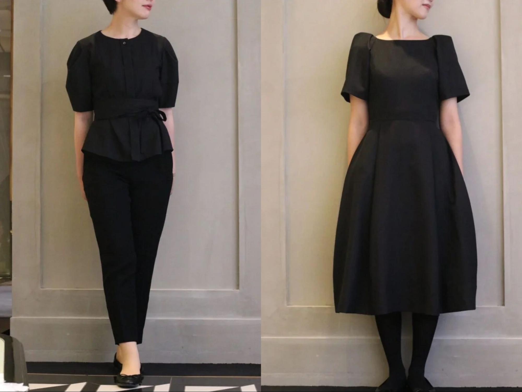 黒のセットアップとワンピースを着用した女性スタッフ